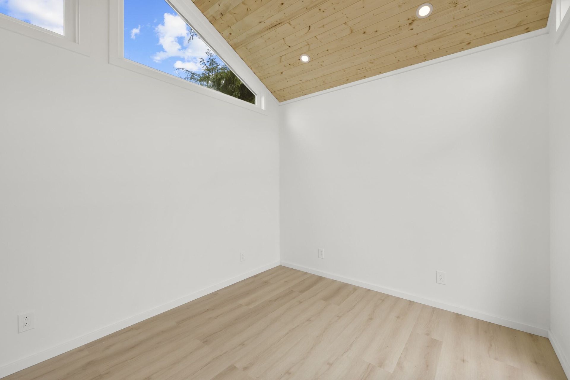 Empty room with wooden ceiling and window