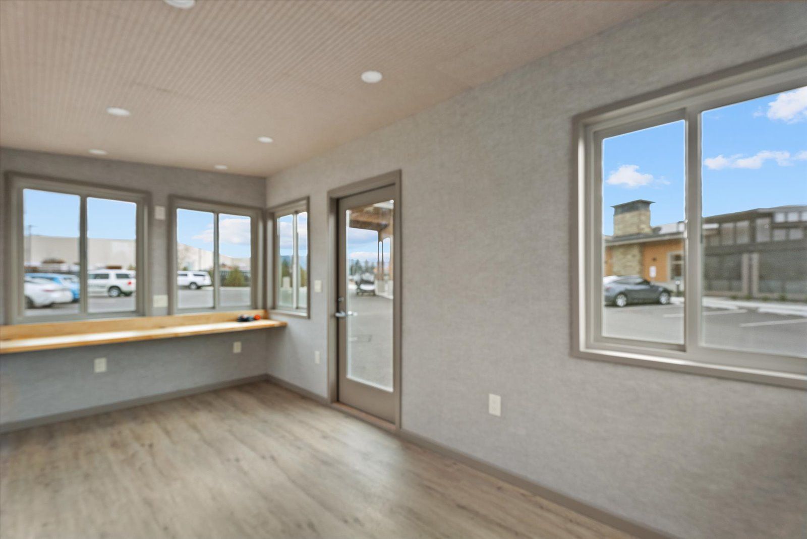 Vacant modern room with light wood flooring