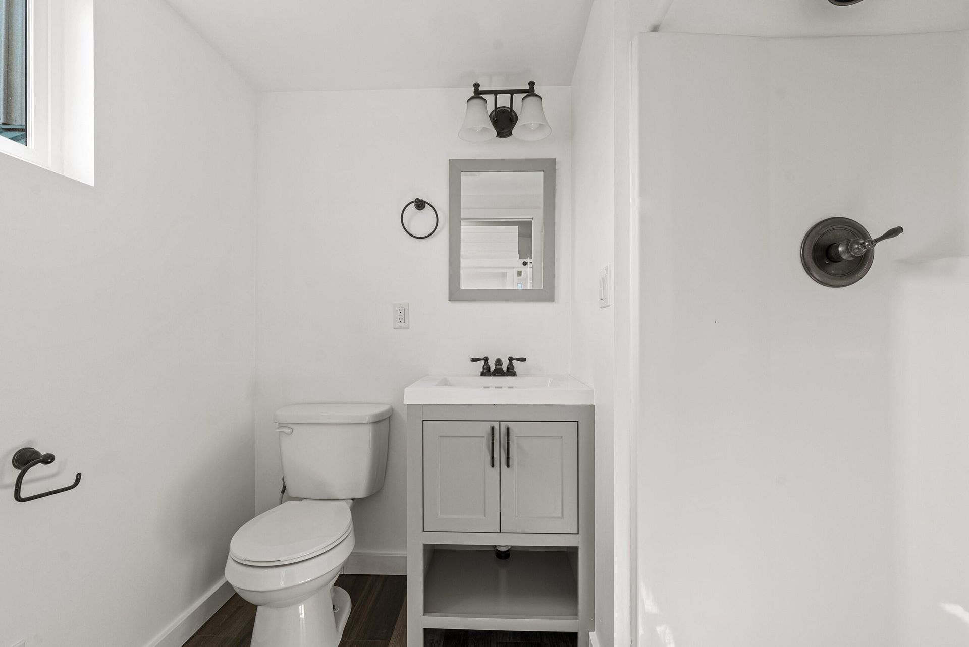 Bathroom with toilet, sink and shower